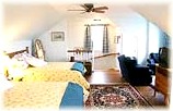 Our Housekeeping Suite features a comfortable sitting area with Satellite TV / VCR, kitchenette, kitchen table, and two quality queen beds and duvets.